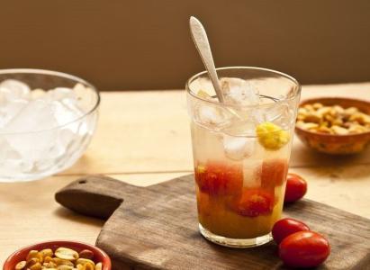 Copo com caipirinha de siriguela em uma mesa