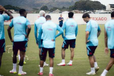 Filipe Luís, ao fundo, observa atividade do elenco do Flamengo no Ninho do Urubu