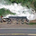 Carreta de cal tomba e motorista fica ferido preso às ferragens na MG-050
