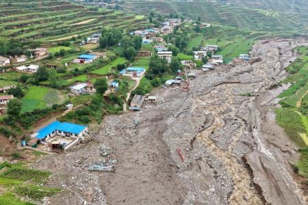 Uma vista aérea mostra carros encalhados (C) em meio a uma enchente devido às fortes chuvas na vila de Xinanzhuang, no distrito de Miyun, nos arredores de Pequim, em 29 de julho de 2025.