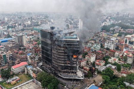 Fumaça sobe dos hotéis Hilton em chamas, um dia após o incêndio ter sido incendiado por manifestantes em Katmandu, em 10 de setembro de 2025.