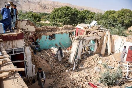 Afghan earthquake survivors search through the remains of a damaged house at a village in Tashqurghan, in the Khulm district of Samangan province on November 3, 2025. A 6.3-magnitude strong earthquake that struck overnight killed at least 20 people in northern Afghanistan, authorities said on November 3, just months after another deadly tremor that left the country reeling. (Photo by Atif ARYAN / AFP)