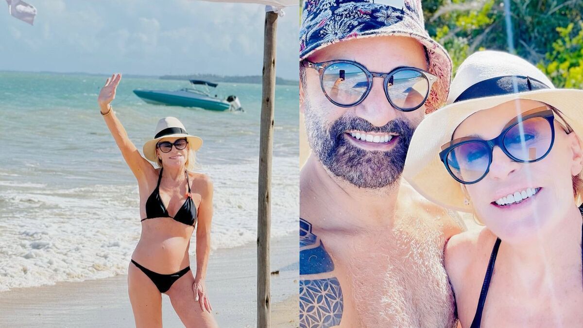 Ana Maria Braga foge de carnaval e exibe corpão em praia ao lado do namorado