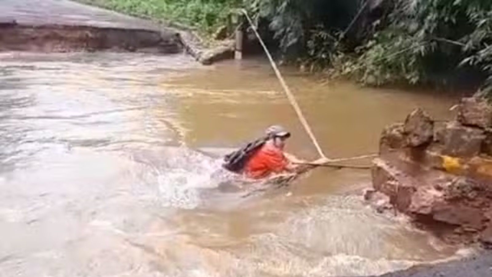 Vídeo: moradores atravessam rio com corda após ponte ser levada pela água em SP