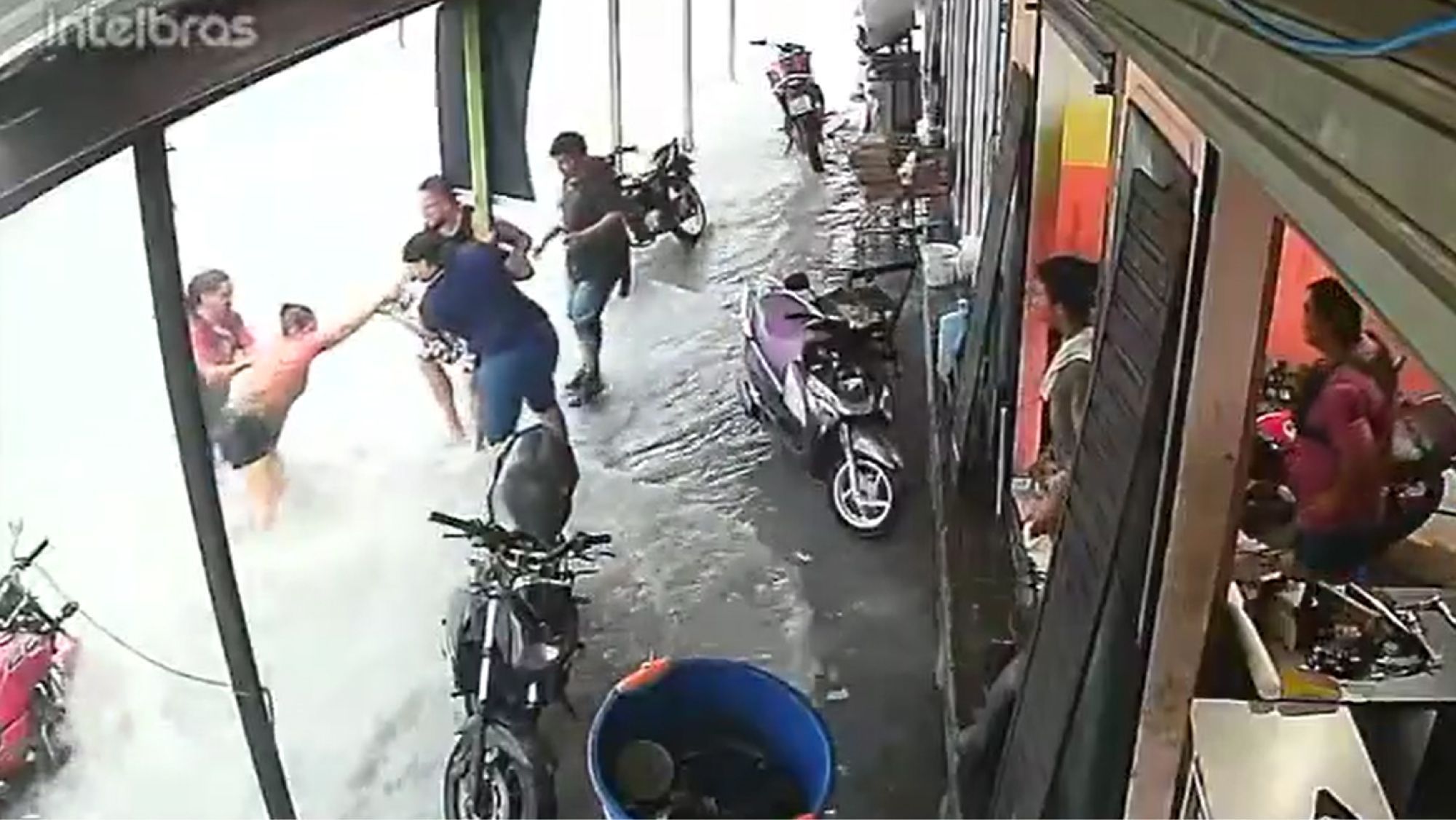 Vídeo: lojista salva mulher arrastada em enxurrada durante temporal em Manaus
