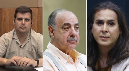 Fuad Noman é um homem branco, de bigode e cabelos brancos. Ele tem olhos claros e na imagem usa uma camisa social laranja claro com um suspensório cinza.