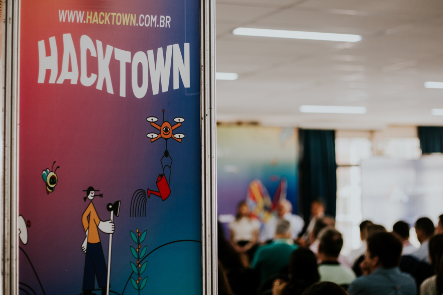 HackTown 2025 reúne gigantes da tecnologia e convida apaixonados por inovação a viver quatro dias de conexões em Minas Gerais