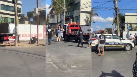 Guarda caído no chão, caminhão e viatura da guarda municipal