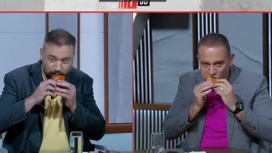 Apresentadores disputaram quem comia cachorro-quente mais rápido