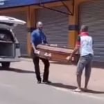 Vídeo: pedestre ajuda funcionário a guardar caixão que caiu de carro funerário