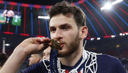 Khvicha Kvaratskhelia, meio-campista do PSG, beija a medalha da Champions League