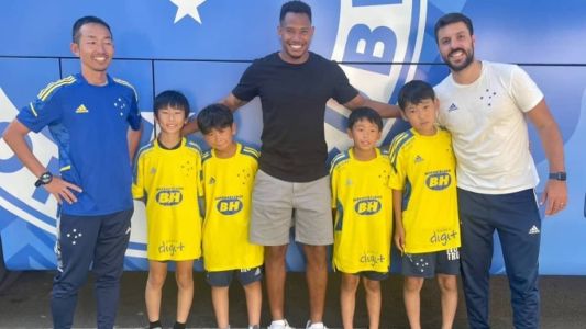 Matheus Jussa, volante do Cruzeiro, posa para foto com meninos japoneses na Toca