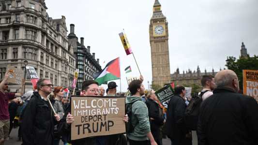 Protesters carry placards and Palestinian flags as they march through Parliament Square with the Houses of Parliament in the background in London on September 17, 2025 during a national march organised by the Stop Trump Coalition against the State Visit of US President Donald Trump. US President Donald Trump arrived in Britain for an unprecedented second State Visit, with the UK government rolling out a royal red carpet welcome to win over the mercurial leader. (Photo by JUSTIN TALLIS / AFP)