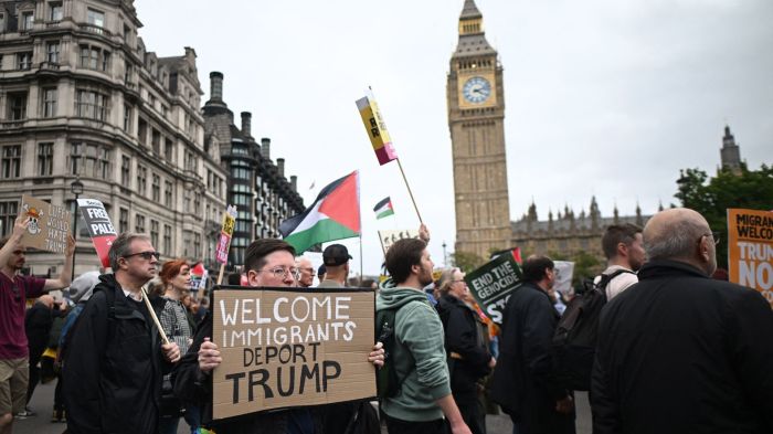 Protesters carry placards and Palestinian flags as they march through Parliament Square with the Houses of Parliament in the background in London on September 17, 2025 during a national march organised by the Stop Trump Coalition against the State Visit of US President Donald Trump. US President Donald Trump arrived in Britain for an unprecedented second State Visit, with the UK government rolling out a royal red carpet welcome to win over the mercurial leader. (Photo by JUSTIN TALLIS / AFP)