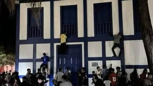 Nas imagens, três homens aparecem escalando prédio