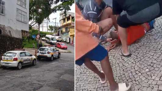 Foto mostra viaturas da Polícia Militar e Guarda Municipal no bairro São Pedro e, à esquerda, homem baleado