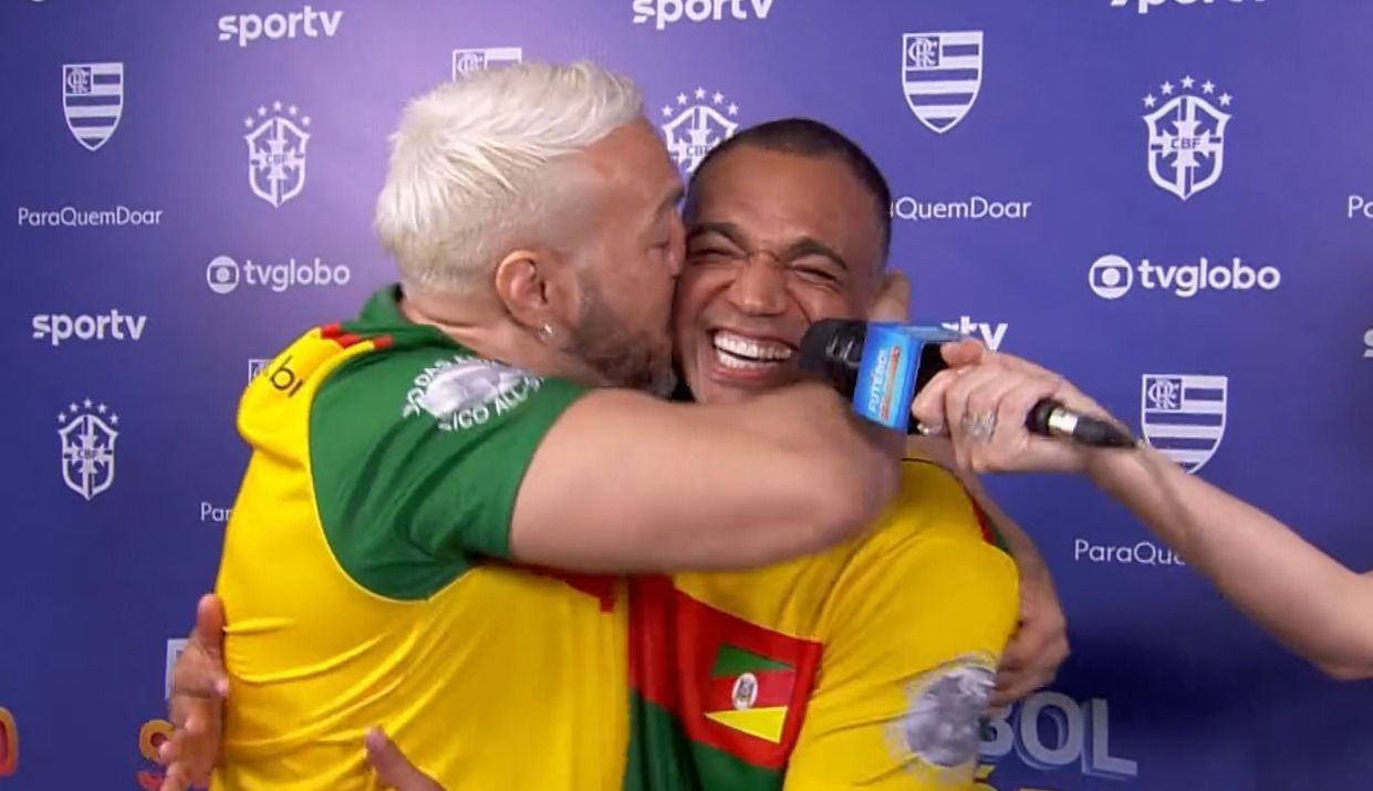 Primeiro encontro de Belo e Denilson tem beijo e alfinetada; veja como foi