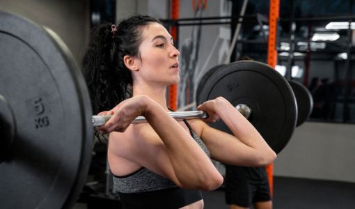 Mulher levantando peso na academia