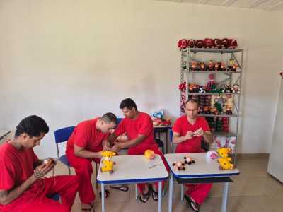 foto mostra detentos costurando brinquedos para serem doados para crianças carentes em Minas Gerais