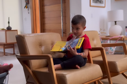 Gaspar, de 4 anos, lê história bíblica para Maria Guilhermina
