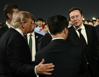 US President Donald Trump (C) presents SpaceX, Twitter and electric car maker Tesla CEO Elon Musk (R) to Chinas Vice President Han Zheng at Beijing Capital Airport in Beijing on May 13, 2026. (Photo by Brendan SMIALOWSKI / AFP) • AFP