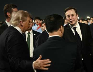 US President Donald Trump (C) presents SpaceX, Twitter and electric car maker Tesla CEO Elon Musk (R) to Chinas Vice President Han Zheng at Beijing Capital Airport in Beijing on May 13, 2026. (Photo by Brendan SMIALOWSKI / AFP) • AFP