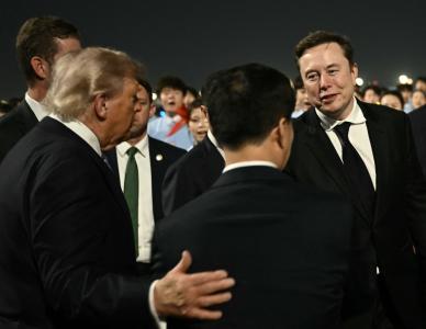 US President Donald Trump (C) presents SpaceX, Twitter and electric car maker Tesla CEO Elon Musk (R) to Chinas Vice President Han Zheng at Beijing Capital Airport in Beijing on May 13, 2026. (Photo by Brendan SMIALOWSKI / AFP) • AFP