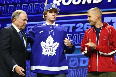 O comissário da NHL, Gary Bettman, observa Gavin McKenna, do Canadá, e o cantor Justin Bieber • Bruce Bennett/Gett