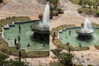 Em meio à onda de calor, moradores se refrescam em chafarizes da Praça Raul Soares, em BH; veja vídeo